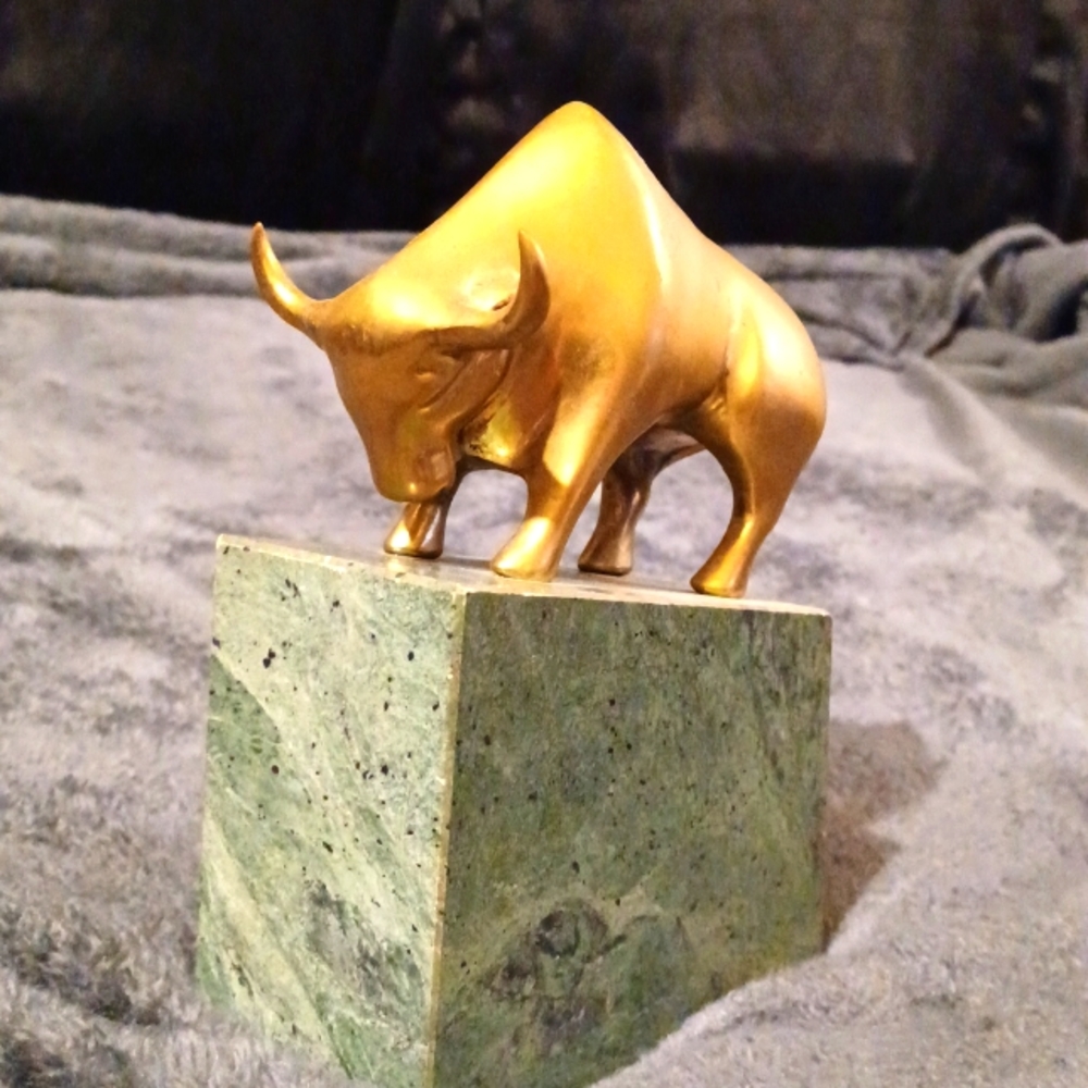 Brass statue on marble top.